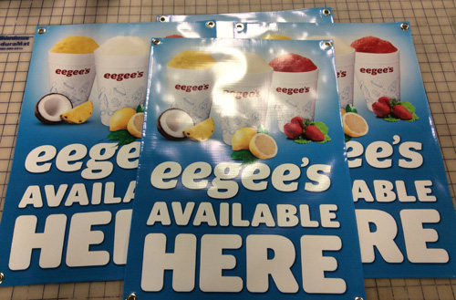 Finished Eegee’s banners photographed on the Innovative Signs production cutting mat.