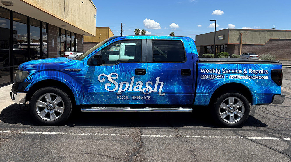 Splash Pools truck with a vivid blue printed water-pattern wrap.